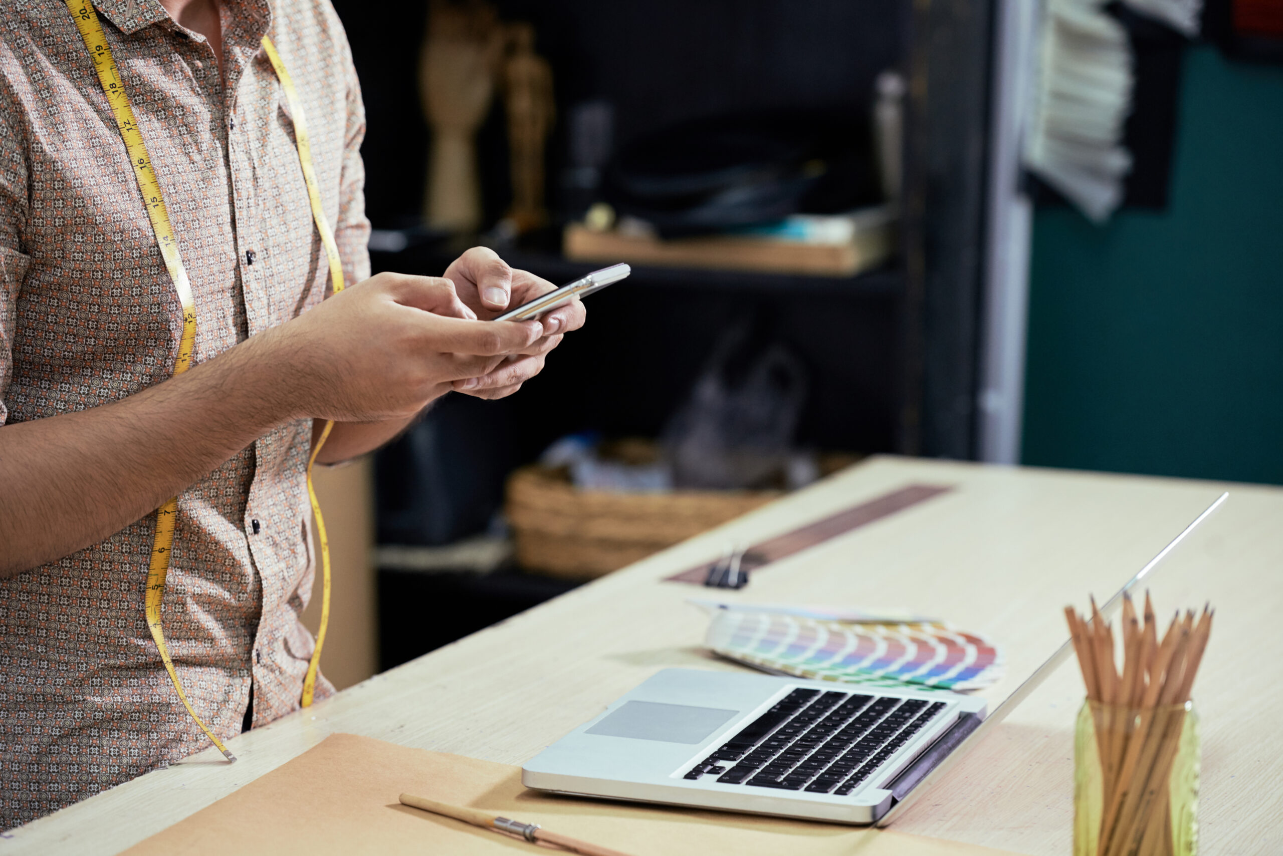 Designer using smartphone at work